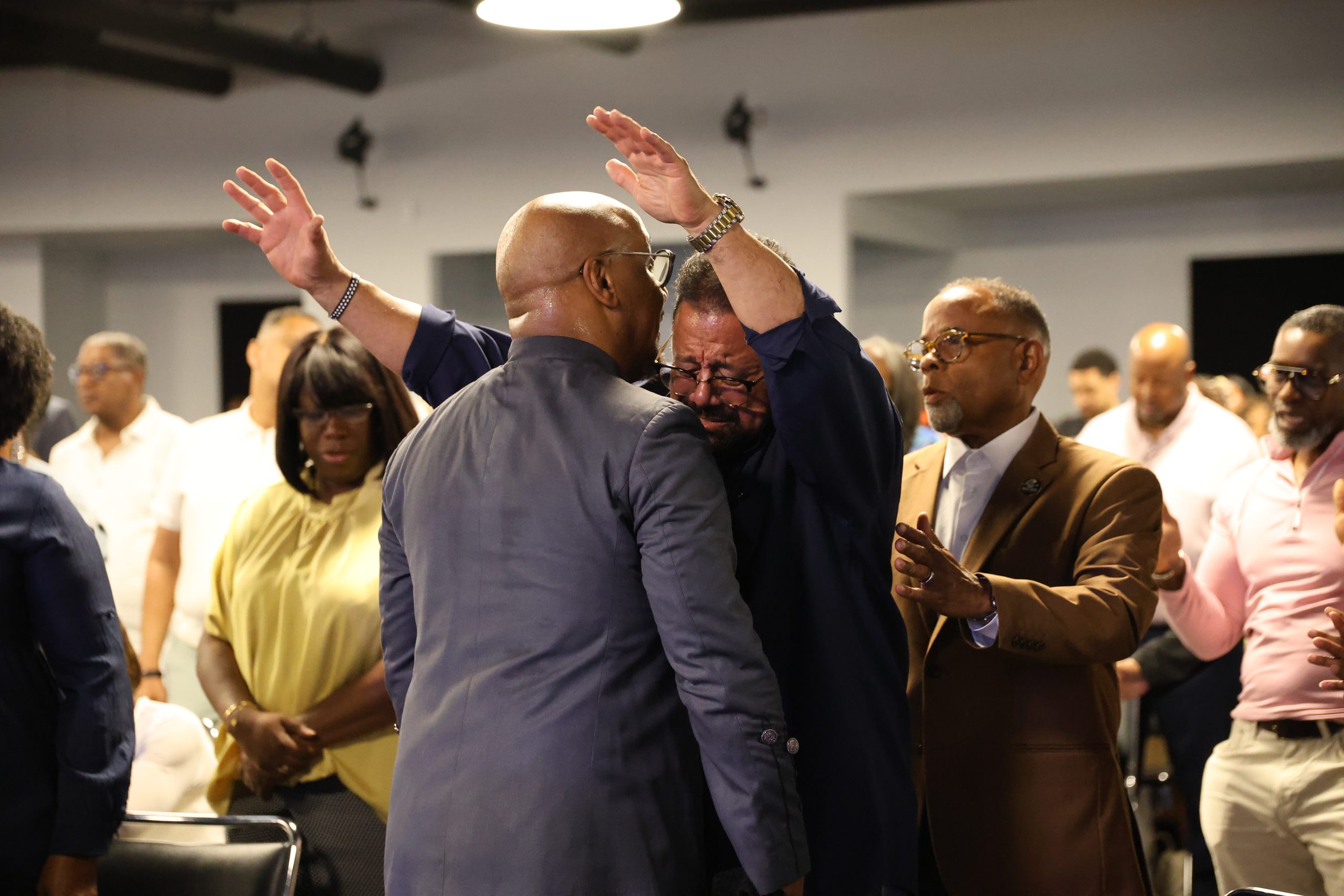 Brothers in prayer at the altar — the covenant community carries one another